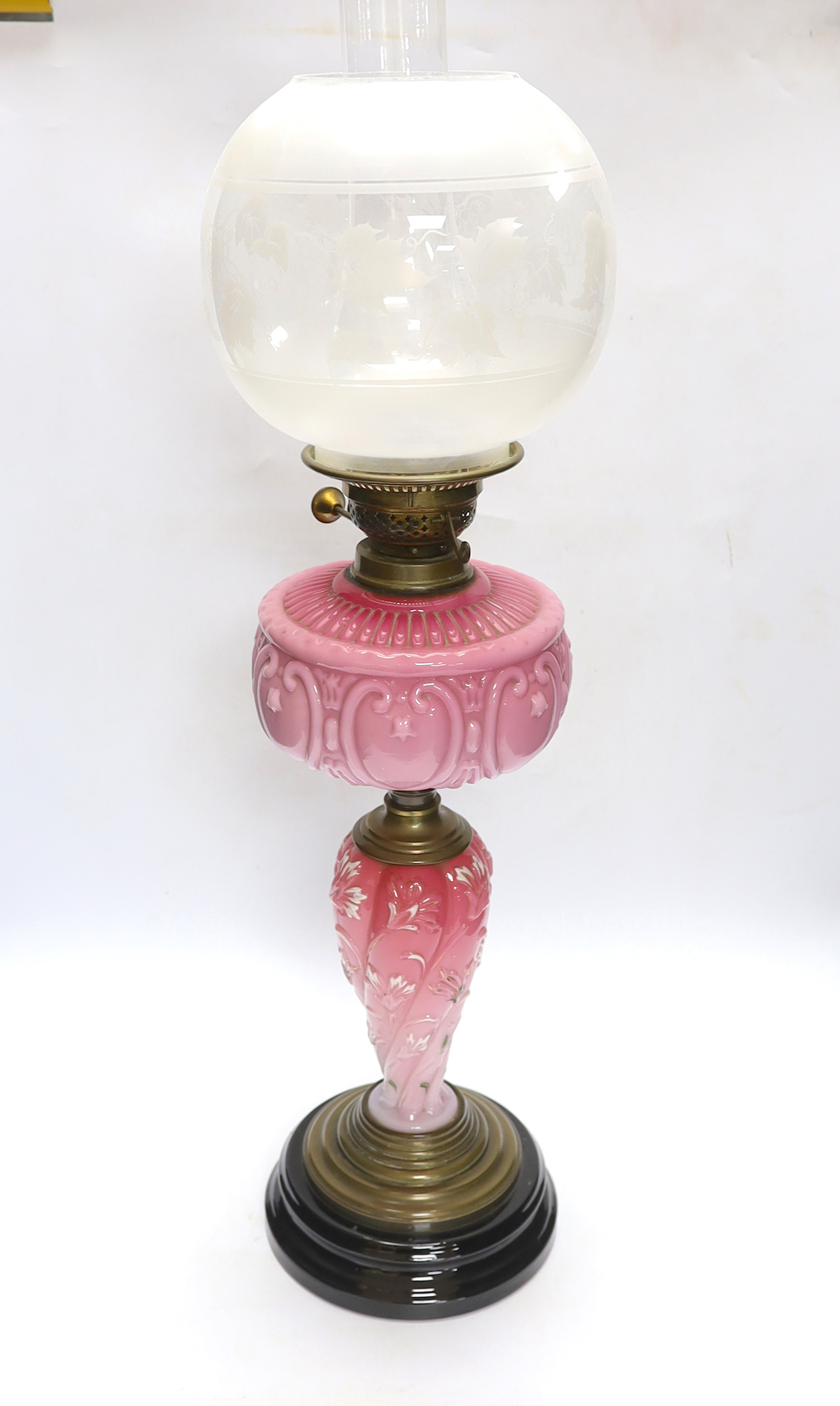 A late 19th century pink and white glass oil lamp, 73cm high
